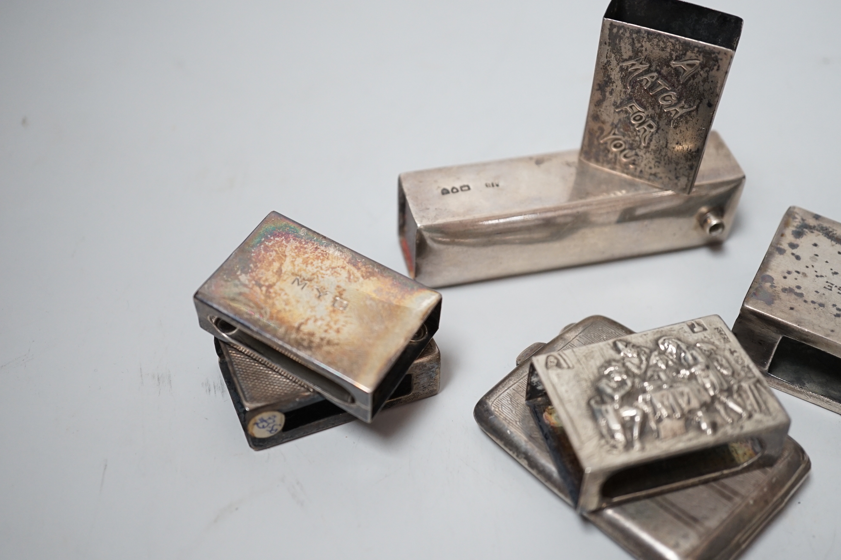 Five assorted mainly early 20th century silver matchbox sleeves and two other items including a matchbook case.